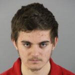 Police tape outside a suburban home at night