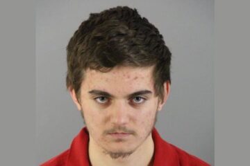 Police tape outside a suburban home at night