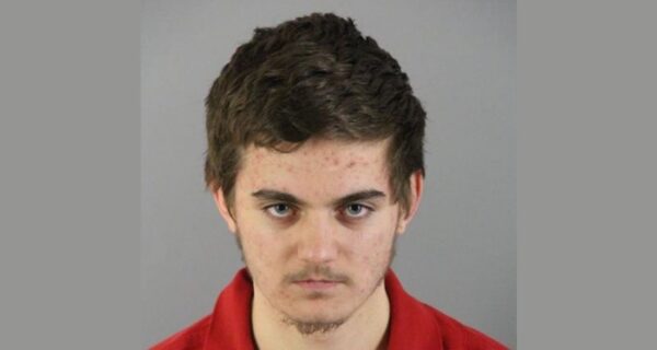 Police tape outside a suburban home at night