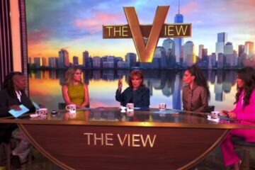 Television talk show stage with hosts and cameras