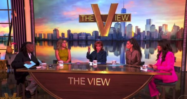 Television talk show stage with hosts and cameras