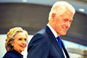 Silhouettes of Bill and Hillary Clinton in front of US Capitol