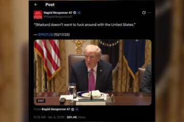Former President Donald Trump speaking during a meeting, discussing relations with Venezuela, with U.S. flags and official decor in the background.