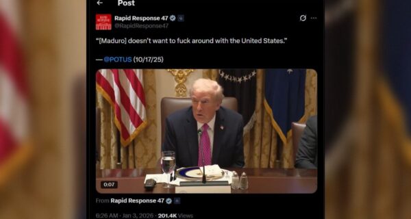 Former President Donald Trump speaking during a meeting, discussing relations with Venezuela, with U.S. flags and official decor in the background.