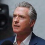 Silhouette of city skyline with dollar signs to suggest wealth leaving