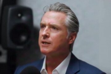 Silhouette of city skyline with dollar signs to suggest wealth leaving