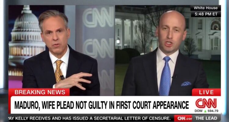 CNN anchors discussing Maduro's court appearance with White House in the background