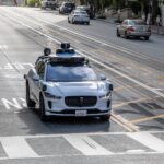 Waymo robotaxi on a California street near emergency scene