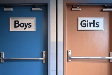 Police badge on a desk with a public library sign blurred in background