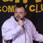 Comedian Ben Bankas performing on stage