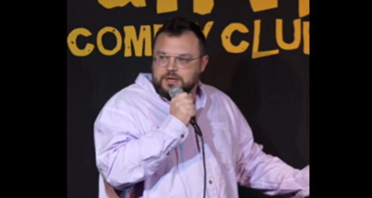 Comedian Ben Bankas performing on stage