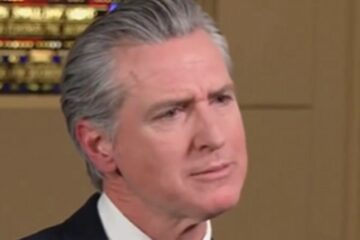 Gavin Newsom speaking in an interview, looking animated