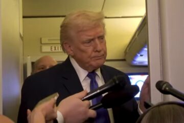 President Donald Trump speaking to reporters aboard Air Force One