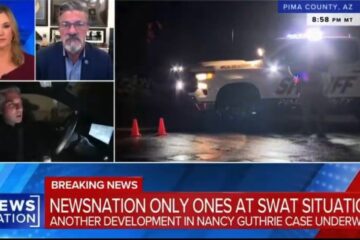 Law enforcement vehicles and SWAT team in a residential Tucson neighborhood at night.