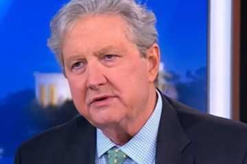 Senator John Kennedy speaking at a podium