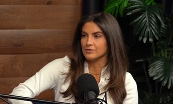 Kaitlan Collins speaking on a podcast microphone