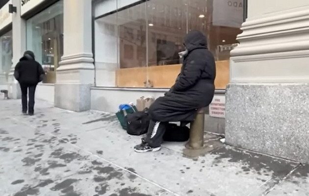 Stretch of NYC street with a warming center sign and snow on the ground