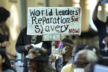 San Francisco city hall at dusk with protesters outside