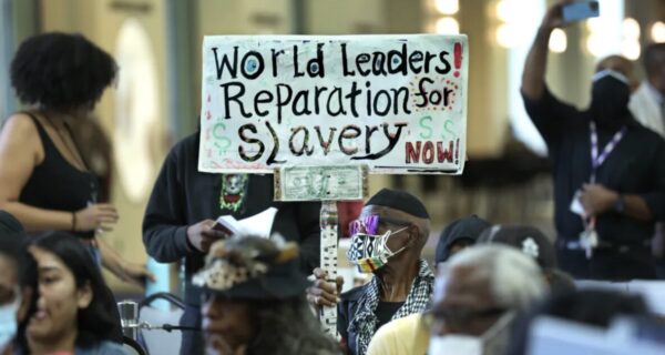 San Francisco city hall at dusk with protesters outside