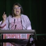 Rep. Rashida Tlaib speaking at a podium