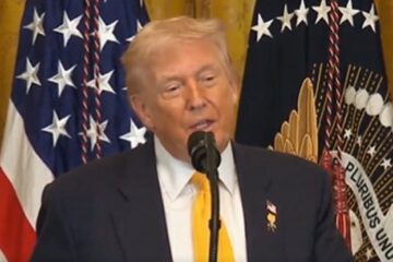 President Donald Trump speaking at White House; Dr. Ben Carson applauding