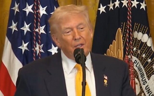 President Donald Trump speaking at White House; Dr. Ben Carson applauding