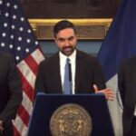 Zohran Mamdani at a podium announcing budget plans