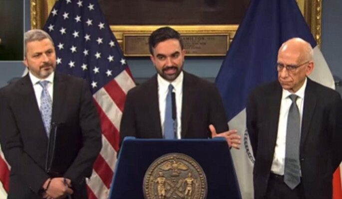 Zohran Mamdani at a podium announcing budget plans