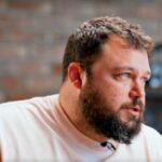 Ben Bankas performing stand-up on stage