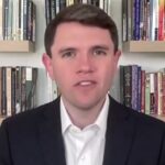 Classroom wall with student essays and political images