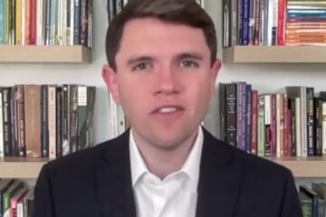 Classroom wall with student essays and political images