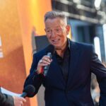 Crowd at concert with ticket price headline