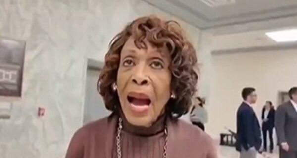 Rep. Maxine Waters speaking at a podium