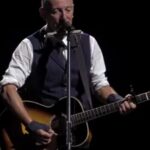 Bruce Springsteen performing on stage in Newark