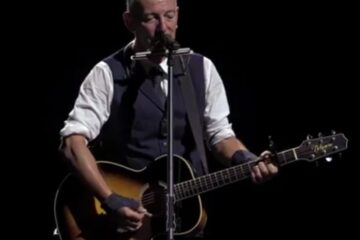 Bruce Springsteen performing on stage in Newark