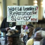 City Hall with Baltimore skyline, representing reparations fund controversy
