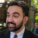 Zohran Mamdani speaking at a public event about city-run grocery stores
