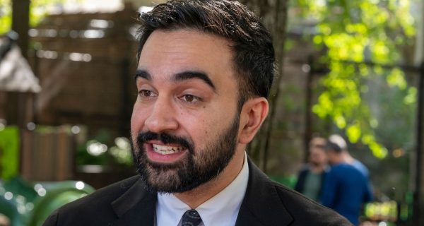 Zohran Mamdani speaking at a public event about city-run grocery stores