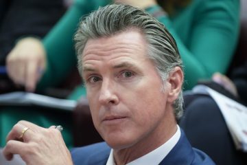 Gavin Newsom speaking at a podium in California