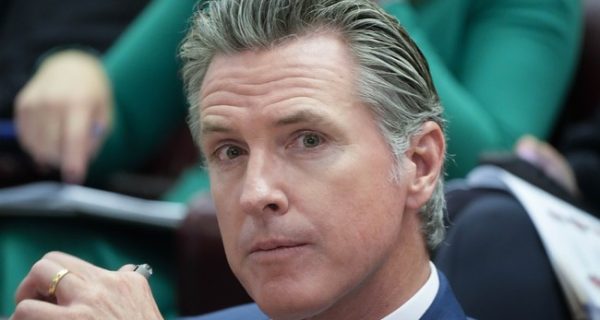 Gavin Newsom speaking at a podium in California