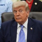 Donald Trump at a podium while Republicans react to a DOJ fund dispute