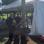 Secret Service agent cuffing a protester at Trump National Doral checkpoint