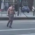 Police officers detain a man in Edinburgh after a series of violent attacks injured five people.