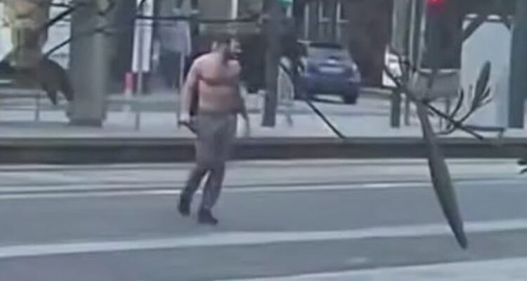 Police officers detain a man in Edinburgh after a series of violent attacks injured five people.