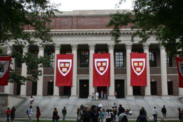 Harvard campus buildings with a story about student mental health and college debt