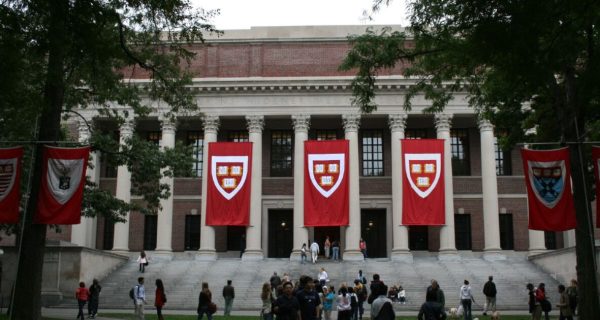 Harvard campus buildings with a story about student mental health and college debt