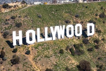 Hollywood sign with a film industry discussion about productions leaving Los Angeles