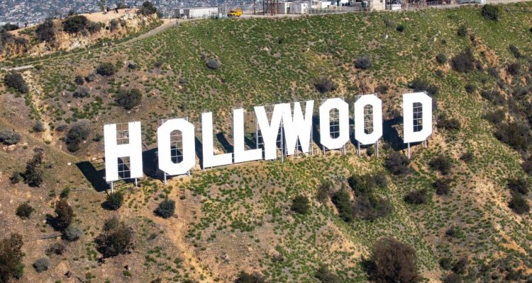 Hollywood sign with a film industry discussion about productions leaving Los Angeles