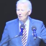 Joe Biden speaking at the Maryland Democratic Party gala while protesters heckle him