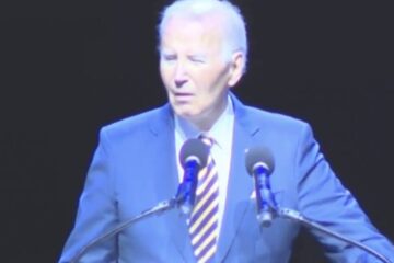 Joe Biden speaking at the Maryland Democratic Party gala while protesters heckle him